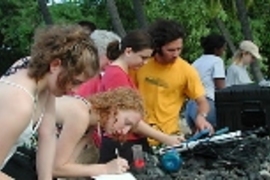 Students Amanda Sorenson, Amber Jaycocks, Barbara Southworth and Andrew Yip calibrate a hydrolab before going out on kayaks to take water quality data.