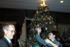 Freshman Benjamin Lu gives President Vest a lesson in contact juggling at Monday's holiday celebration in Gray House.