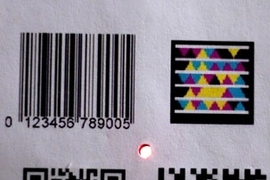 The Bokode device, at center, is much smaller than other types of
barcodes, yet can contain far more information.