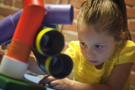 Gabriella, 5, plays with the researchers' toy in the PlayLab at Boston's Children's Museum.