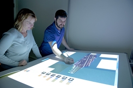 Missy Cummings and student Jason Ryan work on a virtual planning tool designed to organize planes and personnel on aircraft carrier deck.