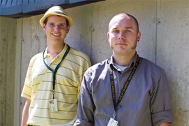 Lincoln Laboratory researchers Gregory Charvat, background, and John Peabody, foreground, stand before the solid concrete wall through which they successfully detected and captured human movement.