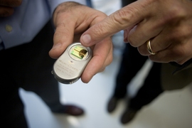 Professors Robert S. Langer (right) and Michael J. Cima speak in the Cima Lab at the David H. Koch Institute for Integrative Cancer Research at MIT. Langer and Cima work together in biotechnology and have developed a new implantable medical device which allows repeated wireless drug delivery in lieu of injections.