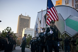 Members of the MIT Police Honor Guard file past the Stata Center as they approach the memorial to Officer Sean Collier at the start of this morning&#39;s ceremony.