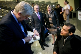  Collins signs a copy of his book, "The Language of Life: DNA and the Revolution in Personalized Medicine."