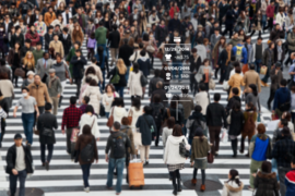 crowd of people crossing a street at a crosswalk