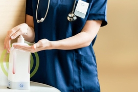 A hospital worker uses a soap dispenser that's been fitted into one of General Sensing's dispenser monitors. 