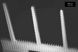 A scanning electron micrograph of the new microfiber emitters, showing the arrays of rectangular columns etched into their sides.