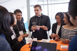 Judges and students talk about projects at the innovation showcase.