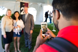 A member of the Class of 2020 has her photo taken with President Reif and his wife, Christine. 