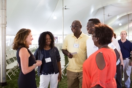 Chancellor Cynthia Barnhart (left) talks with a new student and his family.