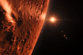 This artist’s impression shows the view from the surface of one of the planets in the TRAPPIST-1 system. At least seven planets orbit this ultracool dwarf star 40 light-years from Earth and they are all roughly the same size as the Earth. Several of the planets are at the right distances from their star for liquid water to exist on the surfaces.