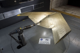 Wing assembly is seen under construction, assembled from hundreds of identical subunits. The wing was tested in a NASA wind tunnel.