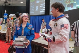 Sophomore Lydia Light, left, prepares her robot for competition, with MechE Associate Professor Amos Winter, right.