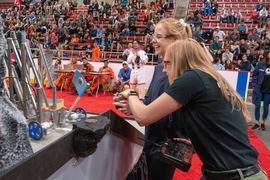 2.007 students remotely control a robot designed to hoist a flag onto a hillside, via a scissor-like mechanism.