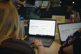 Students work with the En-ROADS software on their laptop computers as part of the “SimPlanet” event, trying out different climate policy options and immediately seeing the outcomes on their screens.