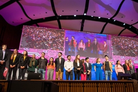 Members of each of the eight student teams take the stage for a final ovation.