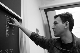 Junior Alex Cuellar with his constructed language. The chalkboard reads: "I can speak Oafal."