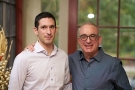 Joshua Angrist and his son Noam Angrist at home standing in front of a window