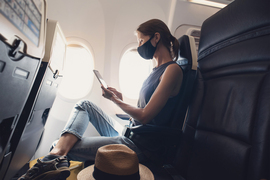 passenger with mask on in airplane