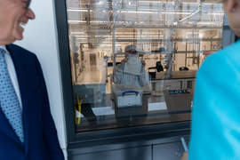 President Reif and Warren looking at a lab technician