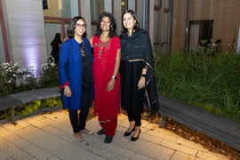 Three women pose outside in the Hayden Library courtyard.