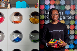 Sadler smiles while holding lots of Legos. Her shirt says, “protect black youth.” The background is a sign that says “Lifelong Kindergarten.”