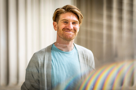 Jackson Jewett smiles with MIT columns in background.