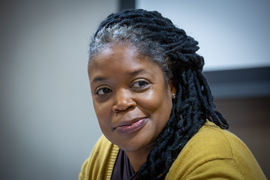 Tracie D. Jones-Barrett smiles while on stage.