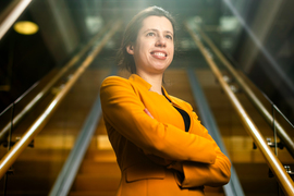 Taken from below, Netta Engelhardt stands with stairs behind her, retreating into the distance.