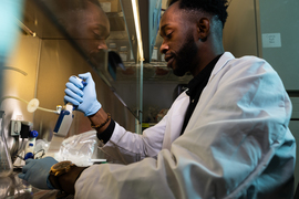 Feyisayo Eweje uses a pipette-style device in the lab.