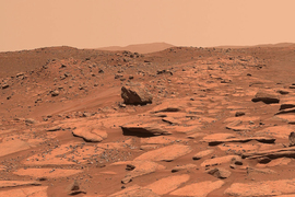 Photo of the brown, rocky, clay Mars surface. 