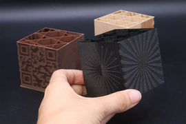 Three textured 3D-printed cubes with interior compartments