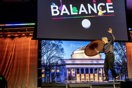 A man walks on a balance beam with the word “Balance” on the screen.