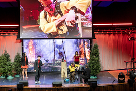 A team on stage demonstrates their respirator, next to Christmas trees.