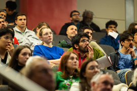 Audience listens to lecture.